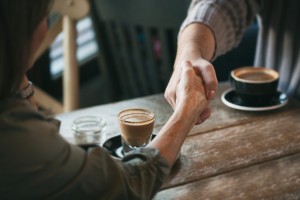 Regular people hanging out in a coffee shop, having drinks, doing work, meeting friends, etc.